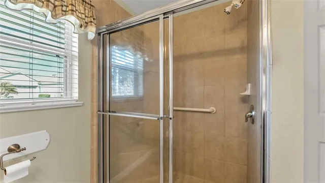 a bathroom with a glass shower door