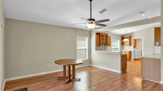 a view of a livingroom with a furniture wooden floor and a chandelier