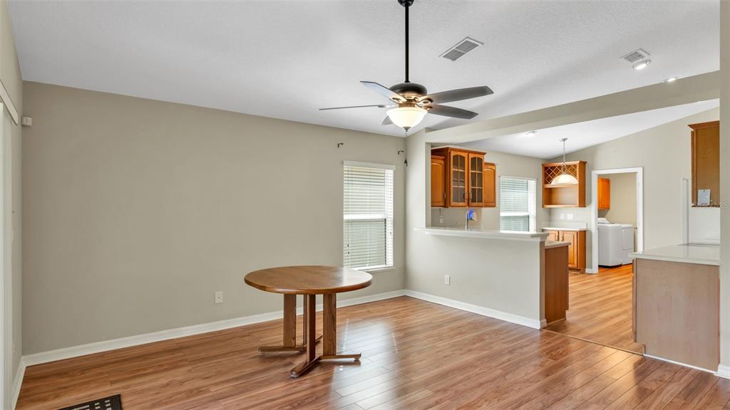 3588 Raleigh Drive Winter Haven, FL 33884 - Photo 10 of 40 a view of a livingroom with a furniture wooden floor and a chandelier