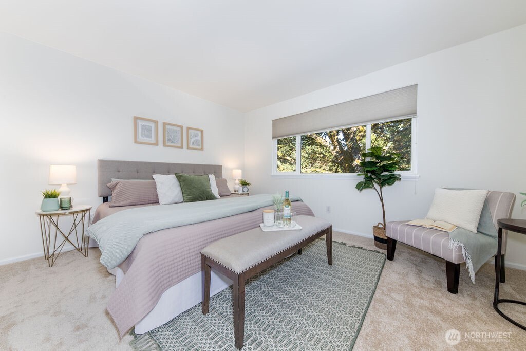 1065 Southwest 12th Street North Bend, WA 98045 - Photo 14 of 27 a bedroom with a bed a table and a potted plant