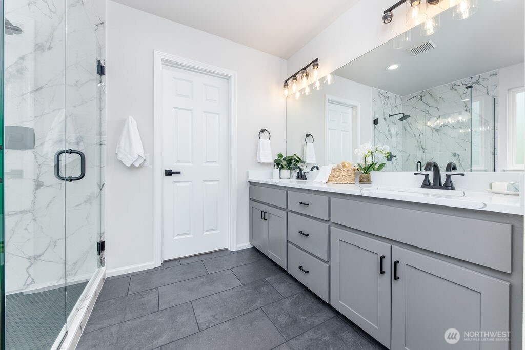 1065 Southwest 12th Street North Bend, WA 98045 - Photo 16 of 27 a spacious bathroom with a granite countertop sink mirror and shower