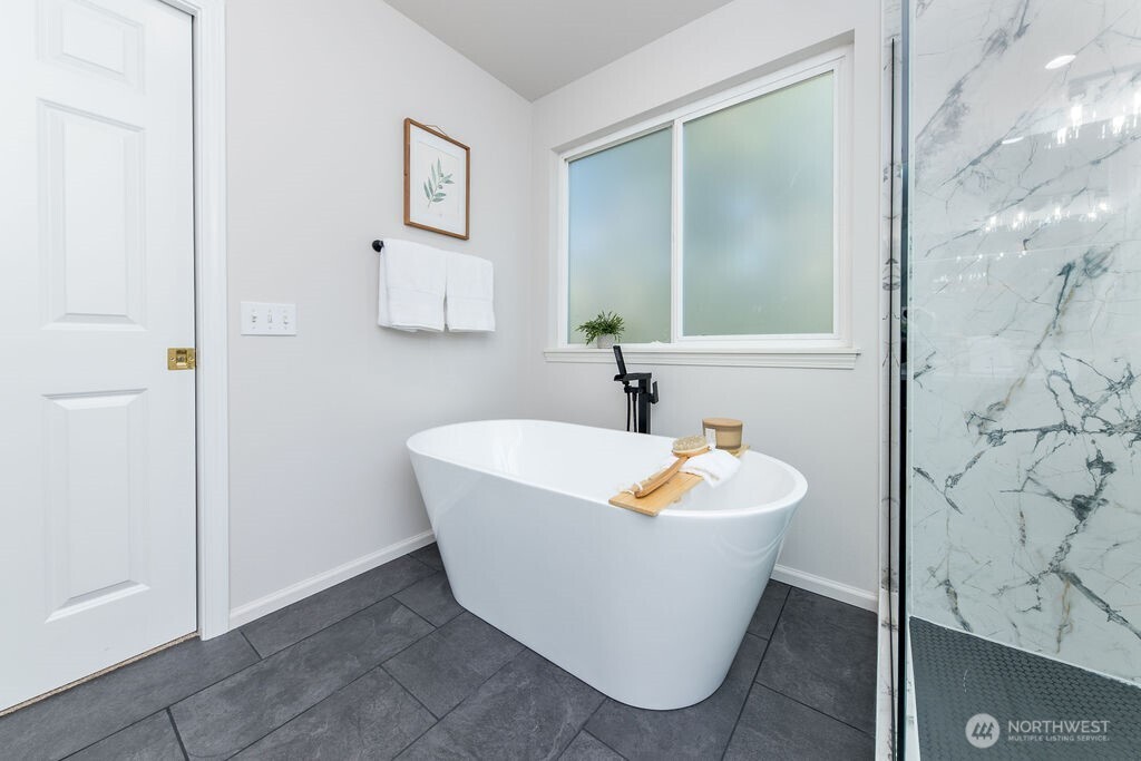 1065 Southwest 12th Street North Bend, WA 98045 - Photo 17 of 27 a white bath tub sitting in a bathroom