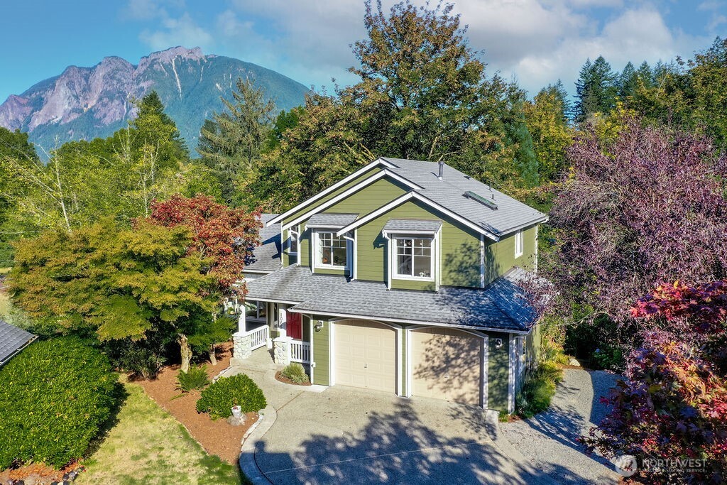 1065 Southwest 12th Street North Bend, WA 98045 - Photo 2 of 27 a front view of a house with a garden