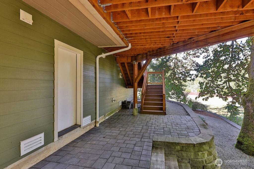 1065 Southwest 12th Street North Bend, WA 98045 - Photo 25 of 27 a view of a patio with table and chairs with wooden floor and fence and a porch