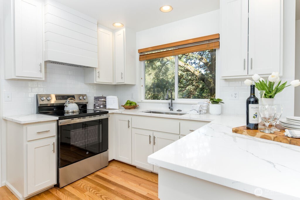 1065 Southwest 12th Street North Bend, WA 98045 - Photo 7 of 27 a kitchen with a white stove top oven and white cabinets