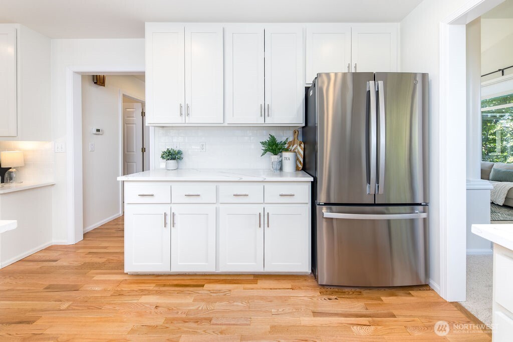 1065 Southwest 12th Street North Bend, WA 98045 - Photo 8 of 27 a kitchen with stainless steel appliances granite countertop a refrigerator microwave and cabinets