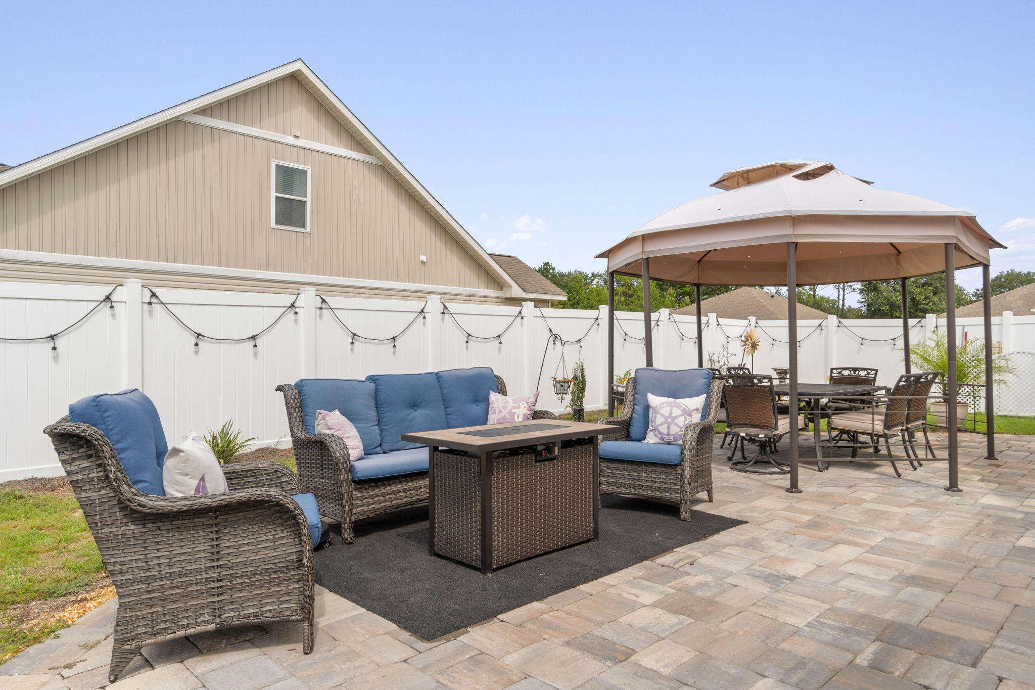 38 Silverthorn Street Freeport, FL 32439 - Photo 5 of 42 a view of a patio with couches and table and chairs under an umbrella