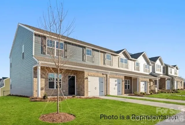 a front view of a building with a garden