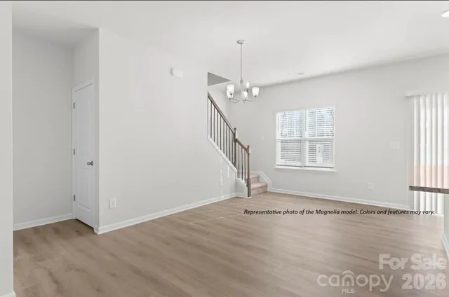 a view of wooden floor and windows in a room