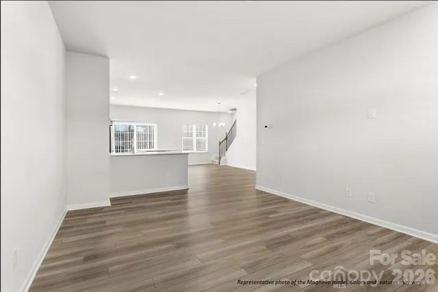 a kitchen with kitchen island granite countertop a stove top oven a sink a counter space and cabinets