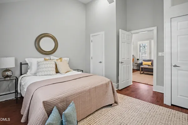 a bedroom with a bed and a lamp on table