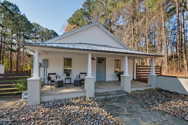 a front view of a house with garden and porch