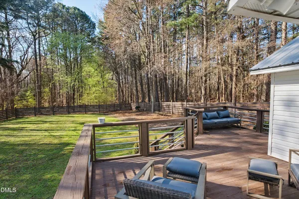 a view of a swimming pool with a patio and a yard