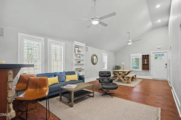 a living room with furniture a rug and a window
