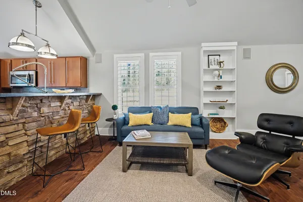 a living room with furniture a rug and a window