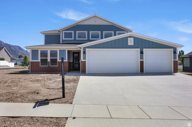 1315 West 3200 South, Unit 17 Perry, UT 84302 - Photo 2 of 58 Two-story residence featuring blue siding and brick accents