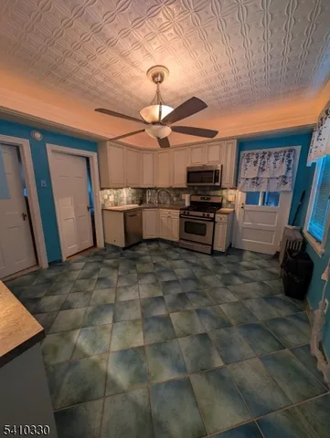 a kitchen with granite countertop a stove and cabinets