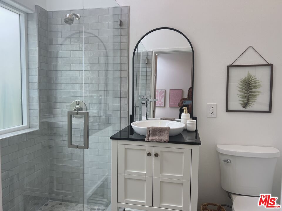 25366 Malibu Road, Unit 2 Malibu, CA 90265 - Photo 16 of 25 a bathroom with a granite countertop sink a toilet and shower