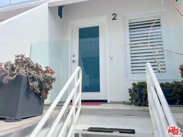 a house with a potted plant on the side