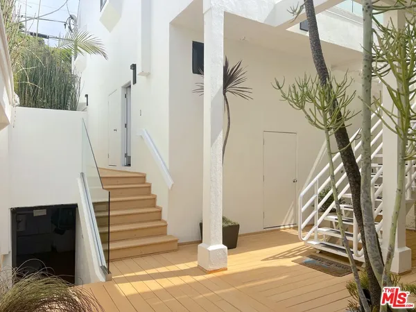 a view of a house with a door and wooden floor