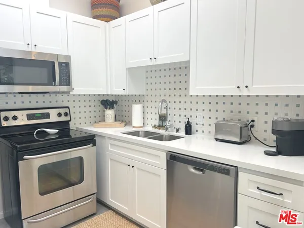 a kitchen with a sink stove and cabinets