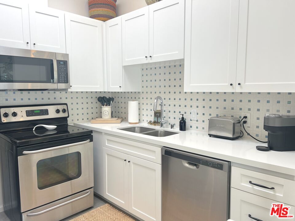 25366 Malibu Road, Unit 2 Malibu, CA 90265 - Photo 8 of 25 a kitchen with a sink stove and cabinets