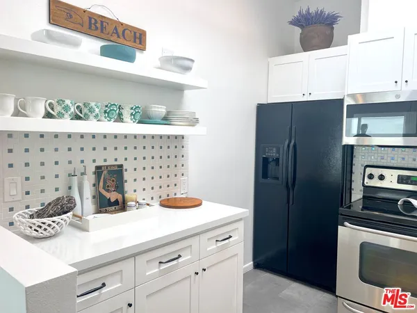 a kitchen with a sink and refrigerator