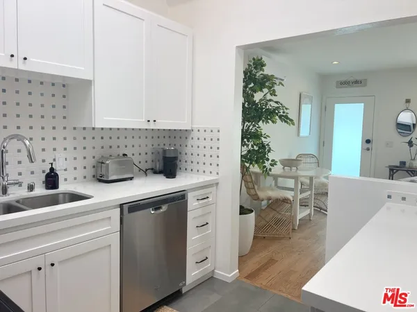 a kitchen with sink and cabinets