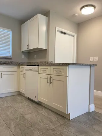 a kitchen with white cabinets