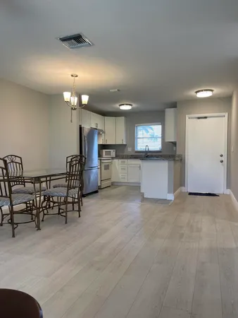 a view of a kitchen with a table and chairs