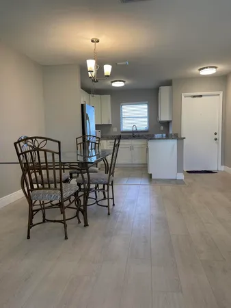 a view of a dining room with furniture and chandelier