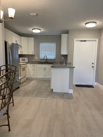 a kitchen with stainless steel appliances granite countertop a refrigerator sink and stove