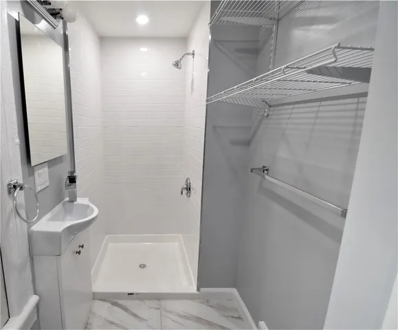 a bathroom with a shower and a sink