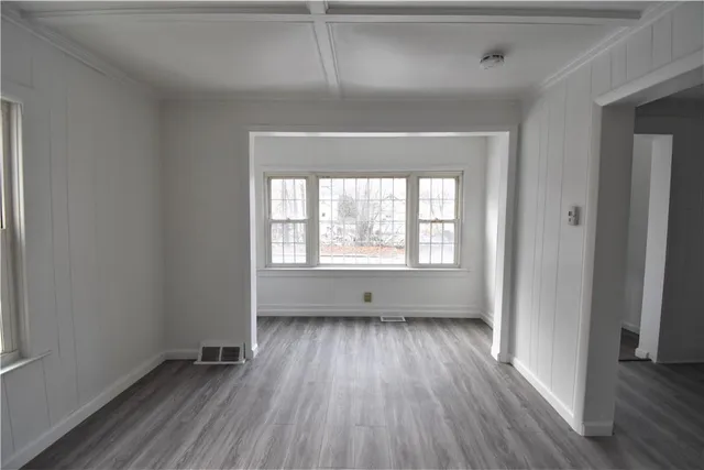 wooden floor in an empty room with a window