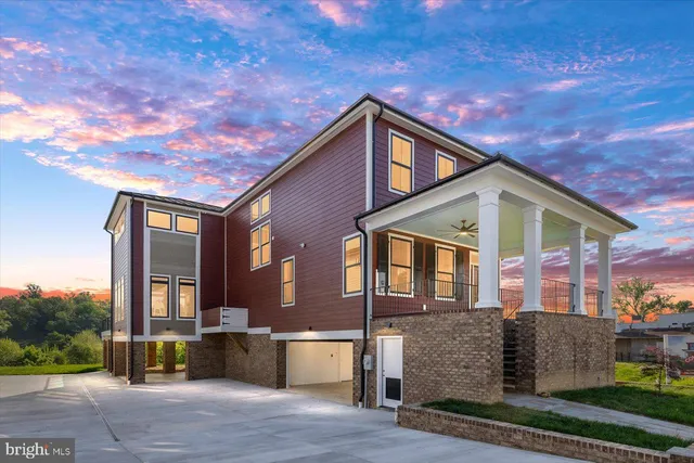 an aerial view of a house with a yard and lake view