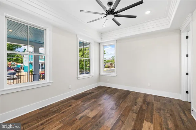 a kitchen with stainless steel appliances a refrigerator a stove a sink and white cabinets