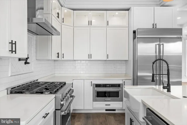 a view of an empty room with kitchen appliances and a window