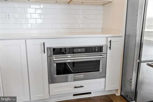 a view of an empty room window and wooden floor