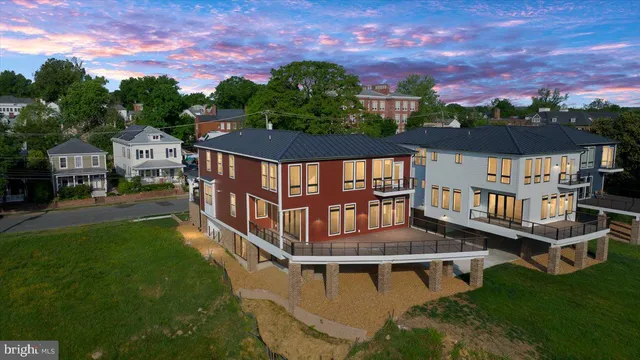 a living room with lots of furniture and view of kitchen