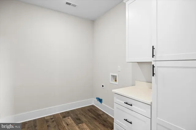 a bathroom with a double vanity sink a toilet and a bathtub