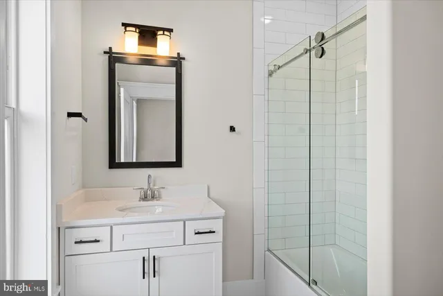 a view of an empty room with a closet and wooden floor