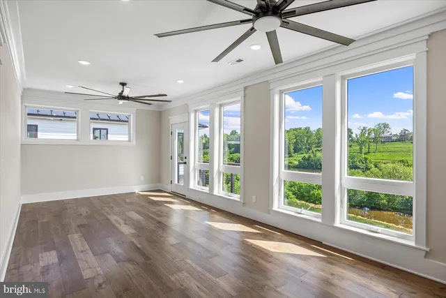 an empty room with a fireplace and large window