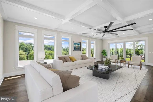 a bed sitting in a spacious bedroom next to a window