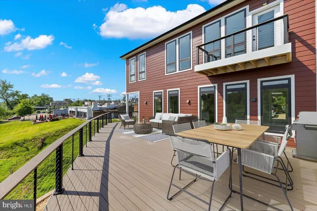 a view of a hallway with wooden floor and a chandelier