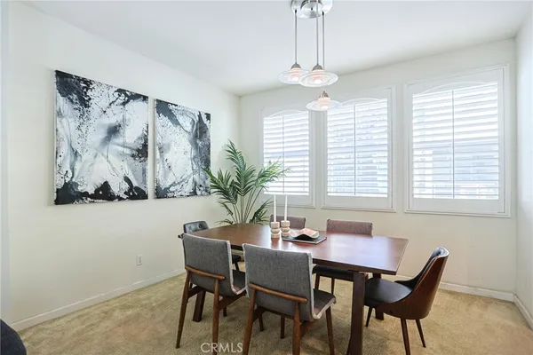 a kitchen with stainless steel appliances granite countertop a stove a sink and a refrigerator with wooden cabinets