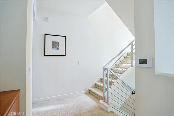 a view of staircase with white walls and windows