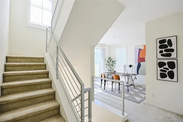 a living room with furniture a table and a large window