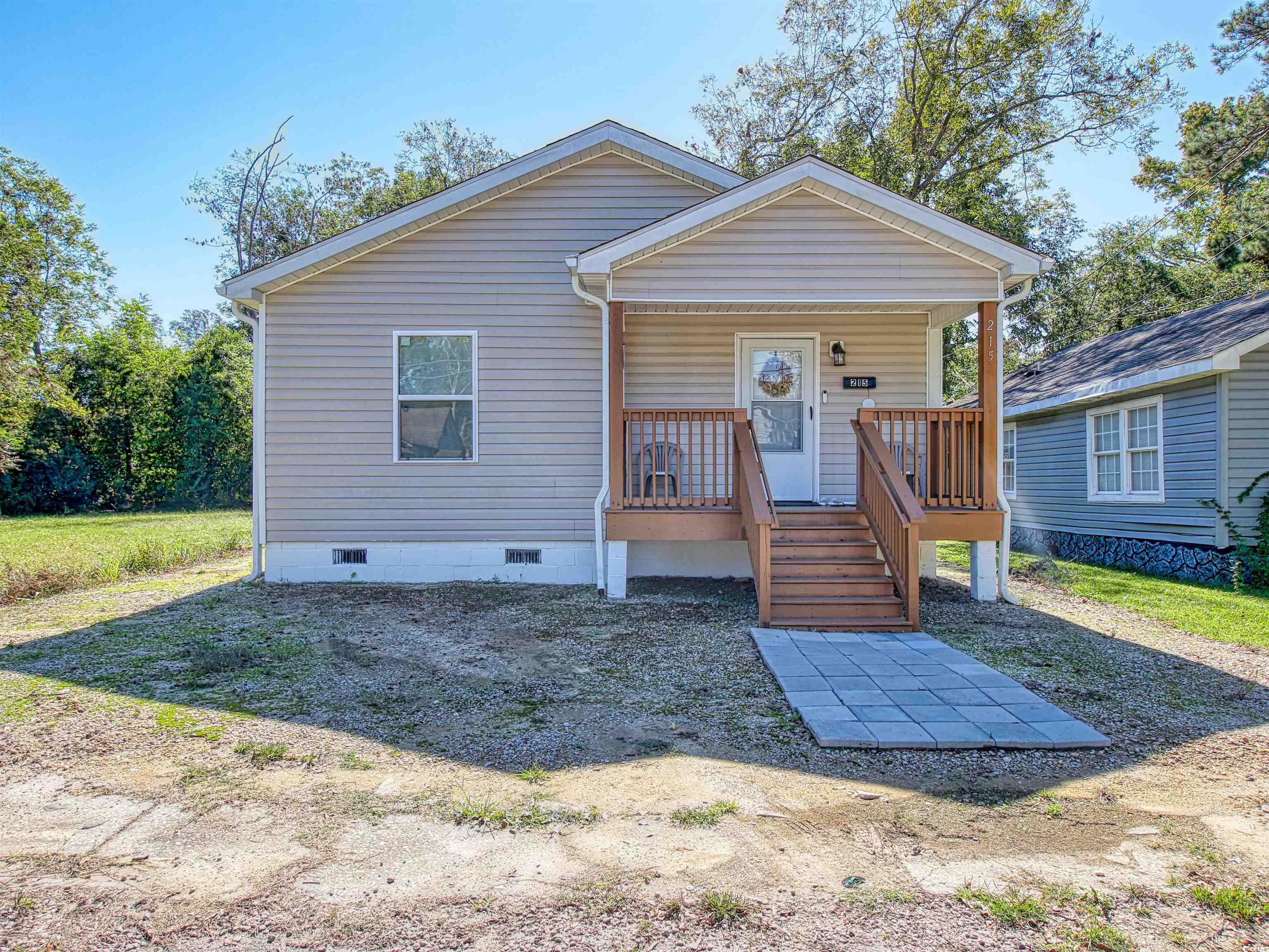 215 West James Street Mullins, SC 29574 - Photo 1 of 18 View of front of house with crawl space and covered porch