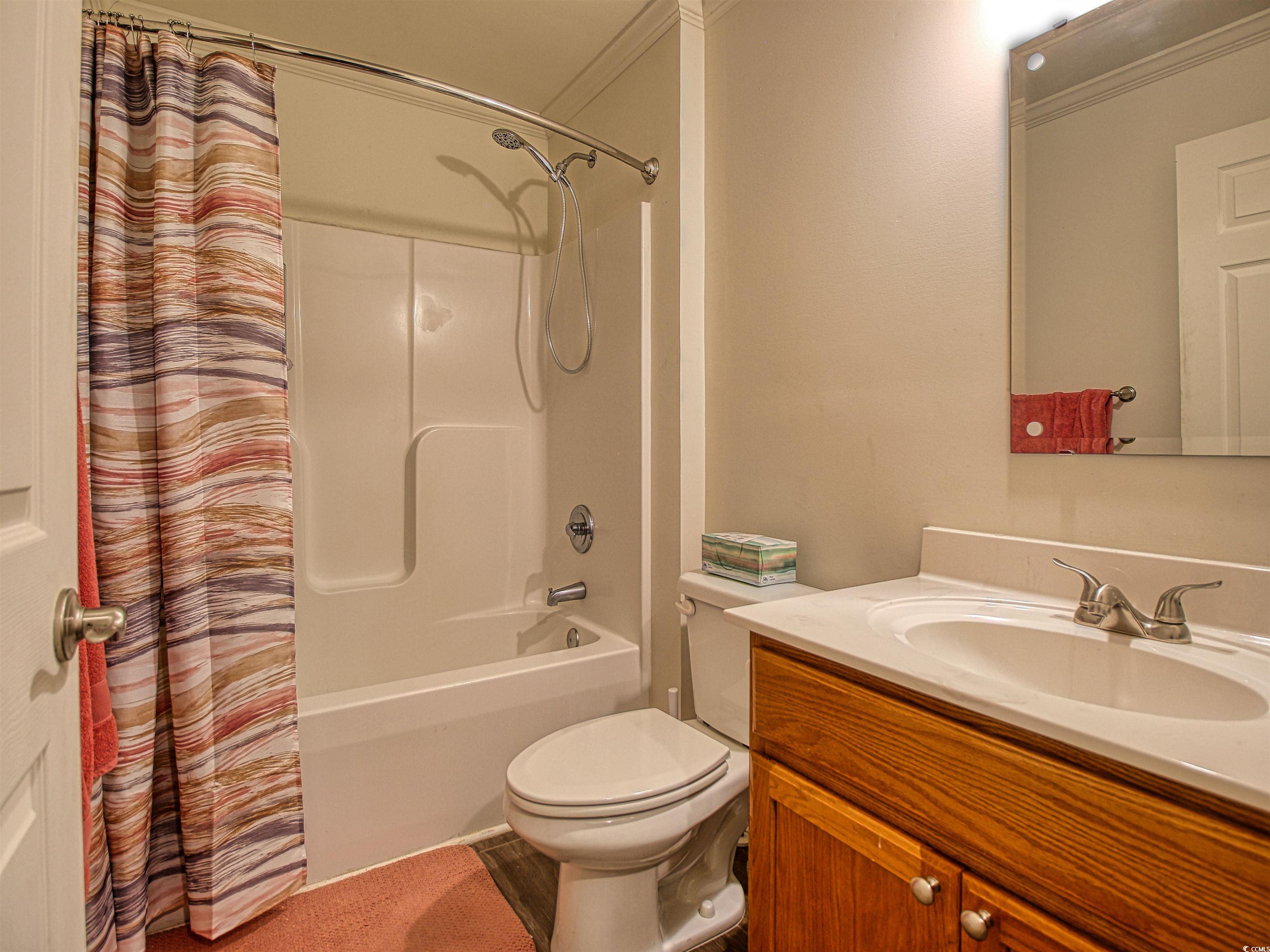 215 West James Street Mullins, SC 29574 - Photo 13 of 18 Bathroom featuring vanity and shower / tub combo