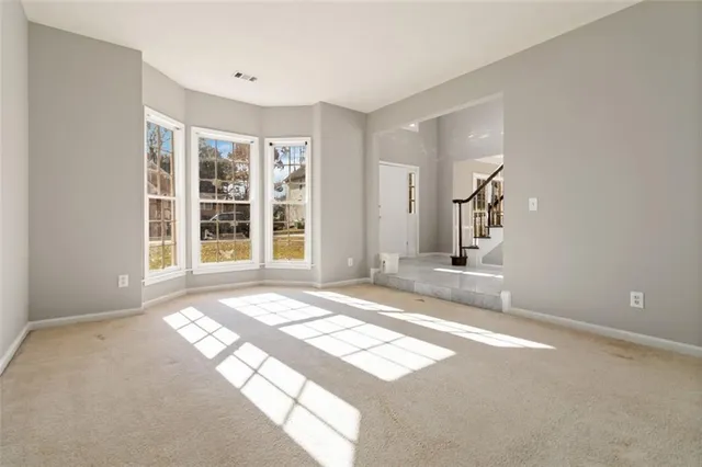 a view of a livingroom with wooden floor and a window